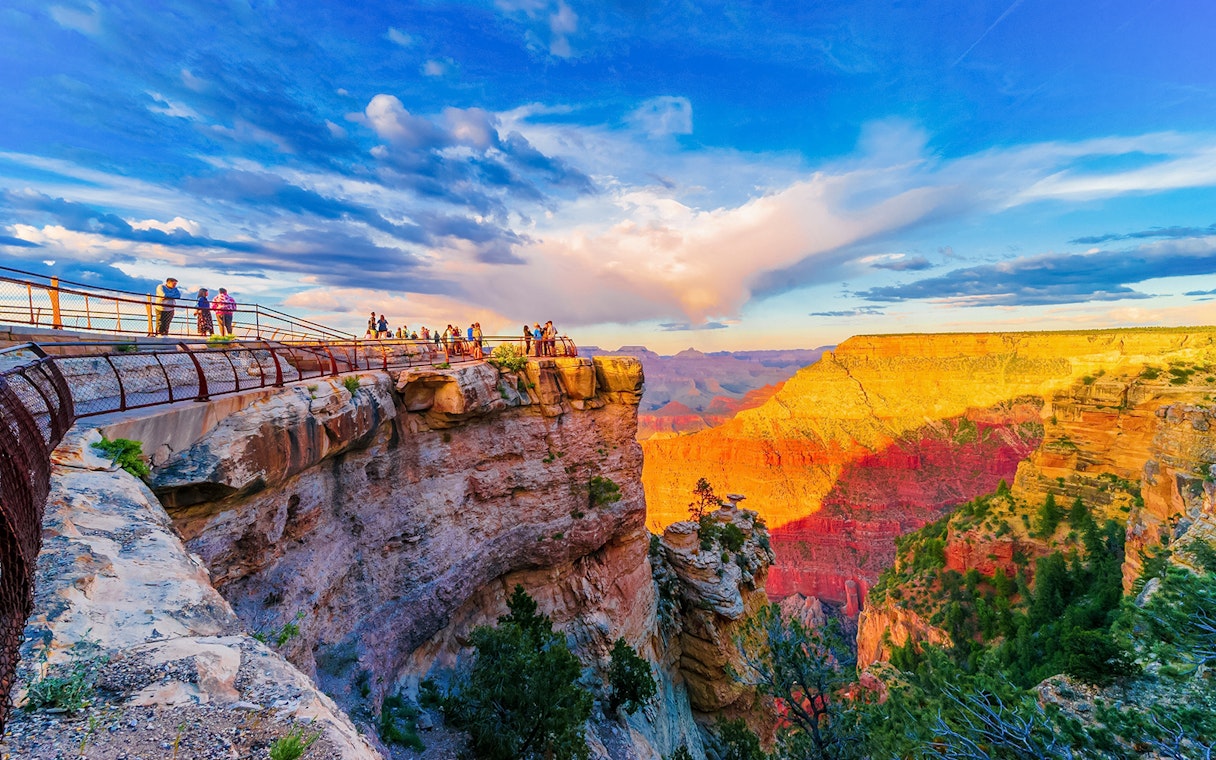 Visitors on the South Rim viewing platform at sunset, Grand Canyon National Park, Arizona, USA.