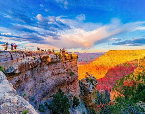 Visitors on the South Rim viewing platform at sunset, Grand Canyon National Park, Arizona, USA.