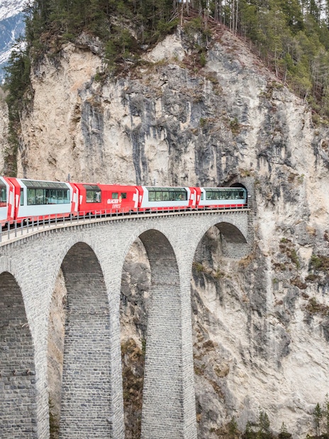 Train crossing Landwasser Viaduct in Swiss Alps.
