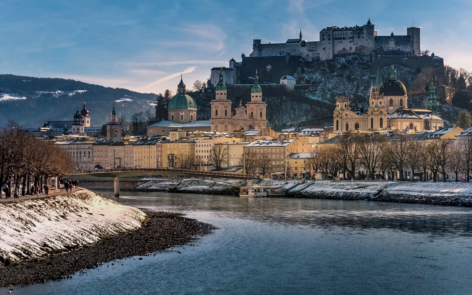 Fortress Hohensalzburg overlooking Salzburg cityscape in winter.