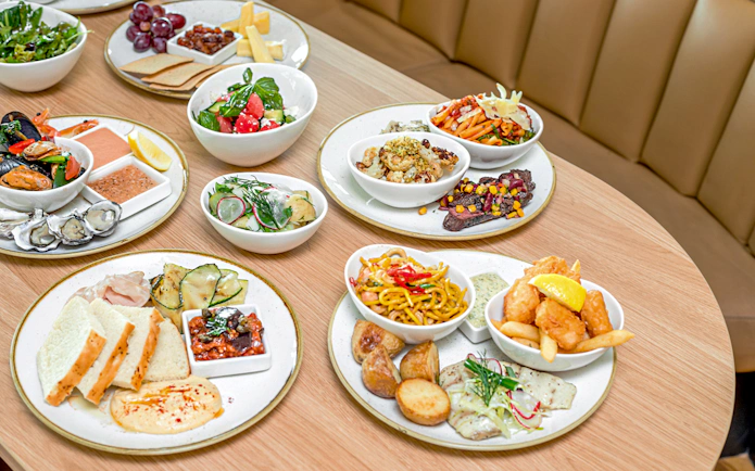 Assorted dishes at SkyFeast, Sydney Tower, featuring seafood, salads, and pasta.