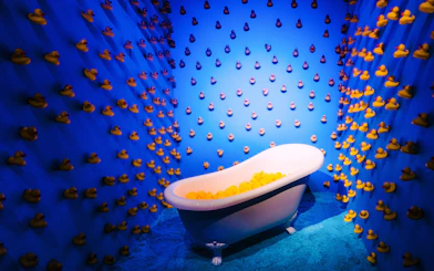 Bathtub filled with rubber ducks in a blue room at Bubble Planet, Cologne.