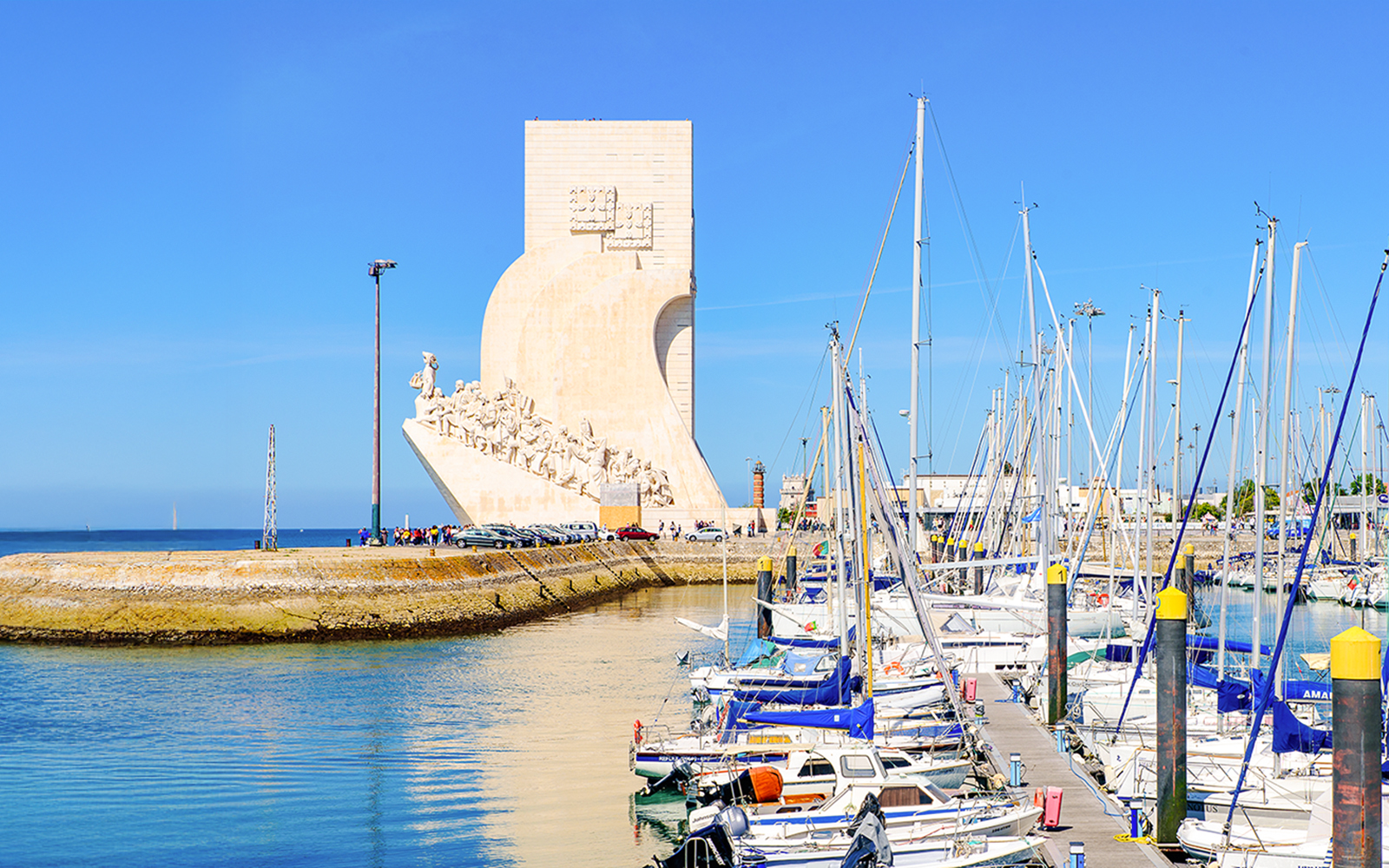 Monument of the Discoveries in Lisbon with marina and sailboats in foreground.