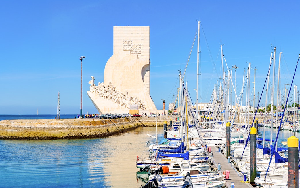 Monument of the Discoveries in Lisbon with marina and sailboats in foreground.
