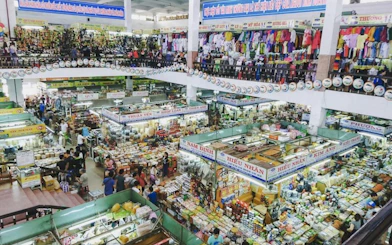 Indoor market bustling with shoppers and vendors, Da Nang Coastal Charm Half-Day Cafe Tour.