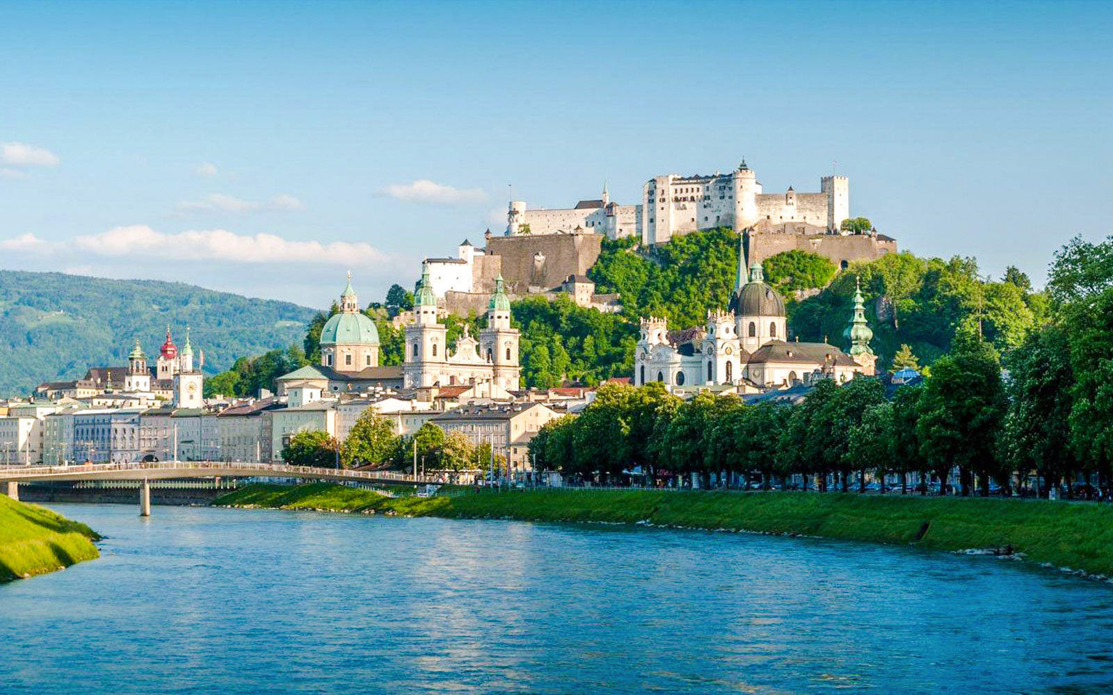 Salzburg cityscape with Hohensalzburg Fortress and Salzach River on hop-on hop-off tour.