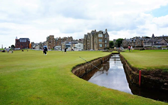 Swilcan Burn flowing through the 1st and 18th fairways of the Old Course at St Andrews, Scotland.