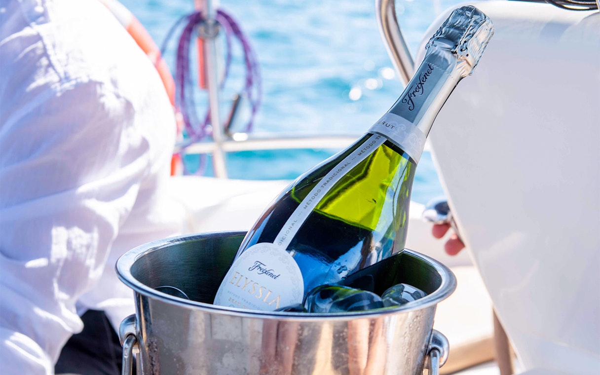 Champagne bottle in ice bucket on sailboat during Magic Sailing Experience.