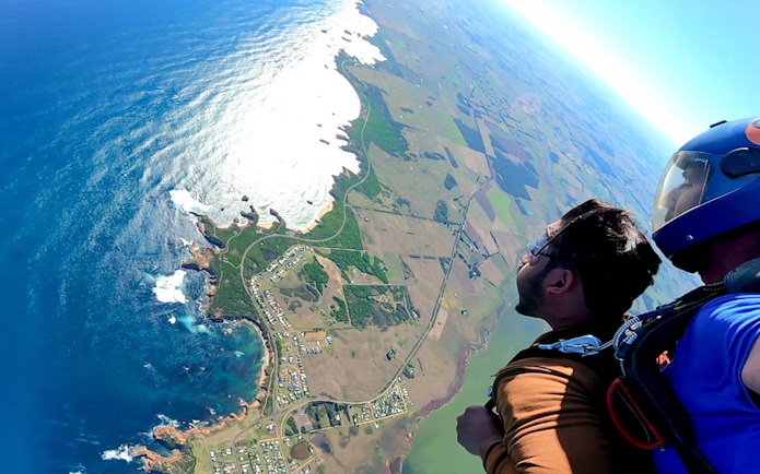 Tandem skydiver views coastal landscape near 12 Apostles, Victoria.