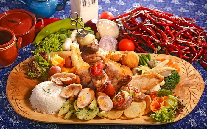 Traditional Hungarian lunch spread with meats, vegetables, and rice during Puszta Day Trip to Kecskemét.