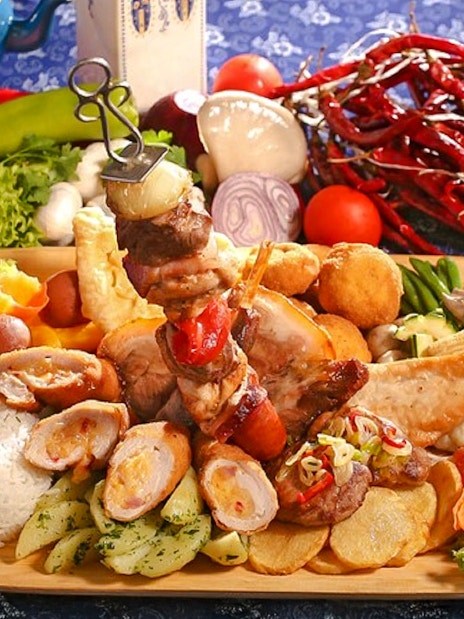 Traditional Hungarian lunch spread with meats, vegetables, and rice during Puszta Day Trip to Kecskemét.
