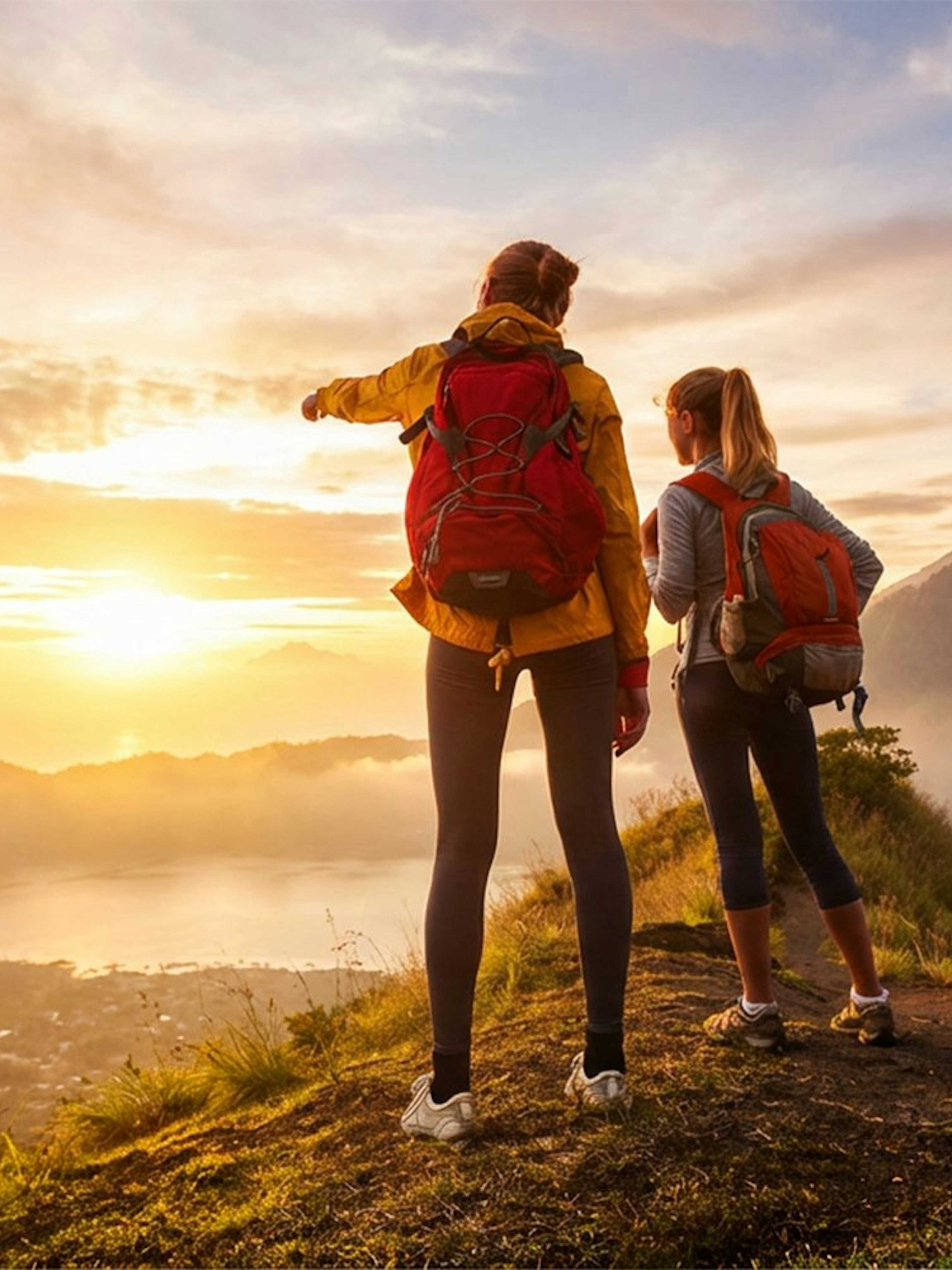 Hikers overlooking sunrise at Mount Batur, Bali.
