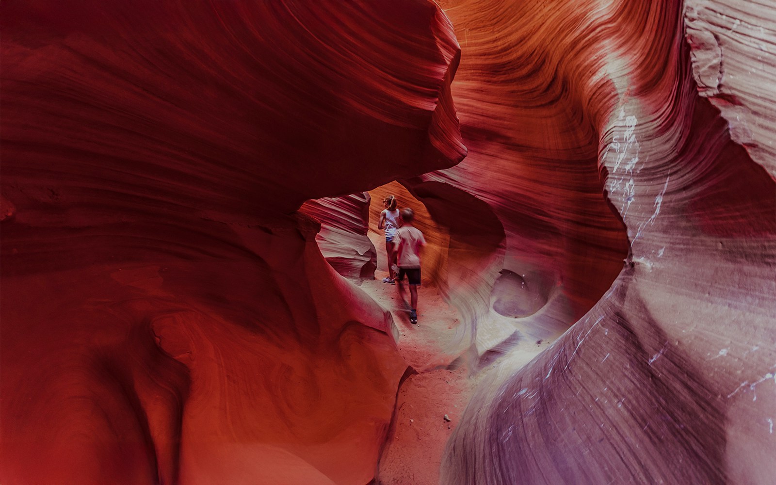 Visitors exploring the vibrant rock formations of Lower Antelope Canyon.