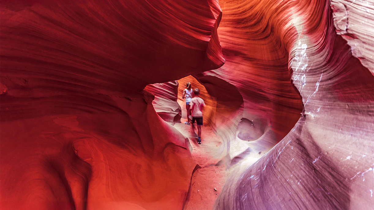 Visitors exploring the vibrant rock formations of Lower Antelope Canyon.