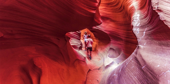 Visitors exploring the vibrant rock formations of Lower Antelope Canyon.