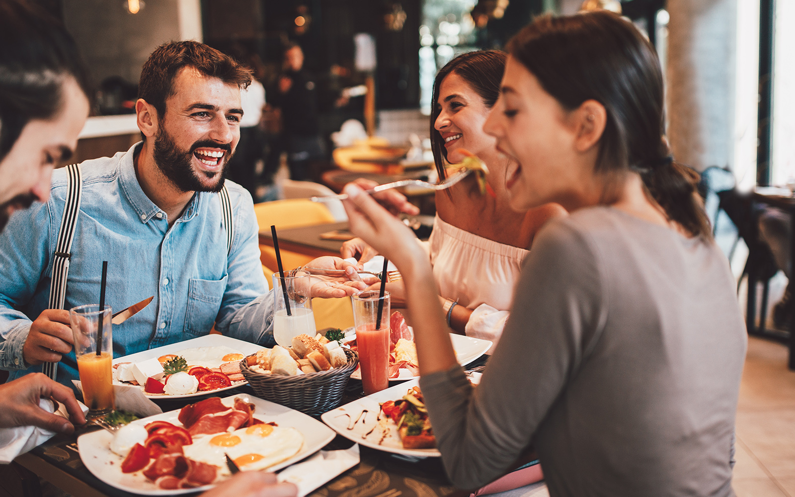 Group of Happy friends having breakfast in Bar Tender Cafe