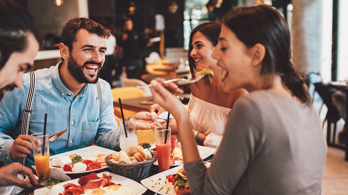 Group of Happy friends having breakfast in Bar Tender Cafe