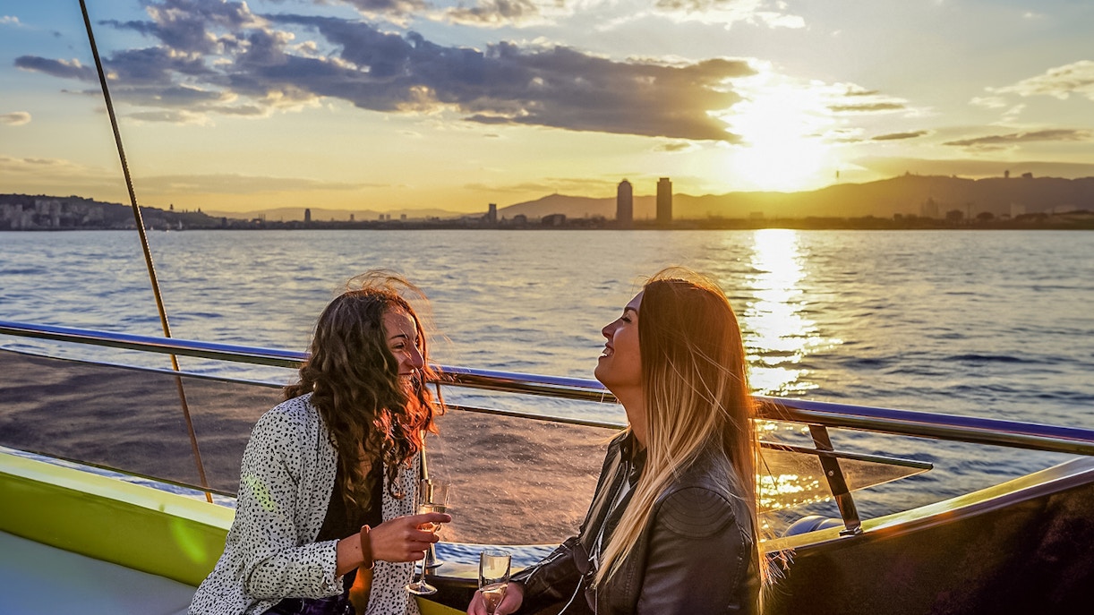 Tourists enjoying a Catamaran Cruise in Barcelona with a view of the city skyline