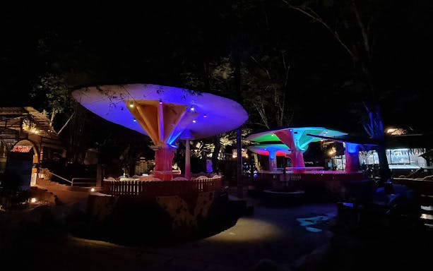 Colorful mushroom-shaped structures illuminated at night in Lost World of Tambun's Hot Springs & Night Park.