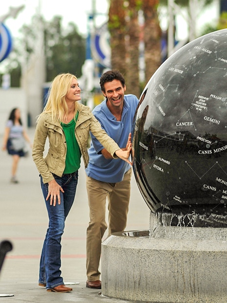 Visitors interact with a constellation globe at Kennedy Space Center, Florida.