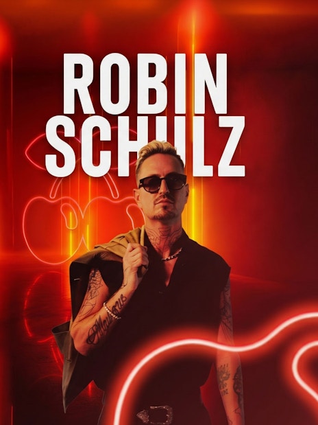 Robin Schulz at Pacha nightclub, Ibiza with neon lights in the background.