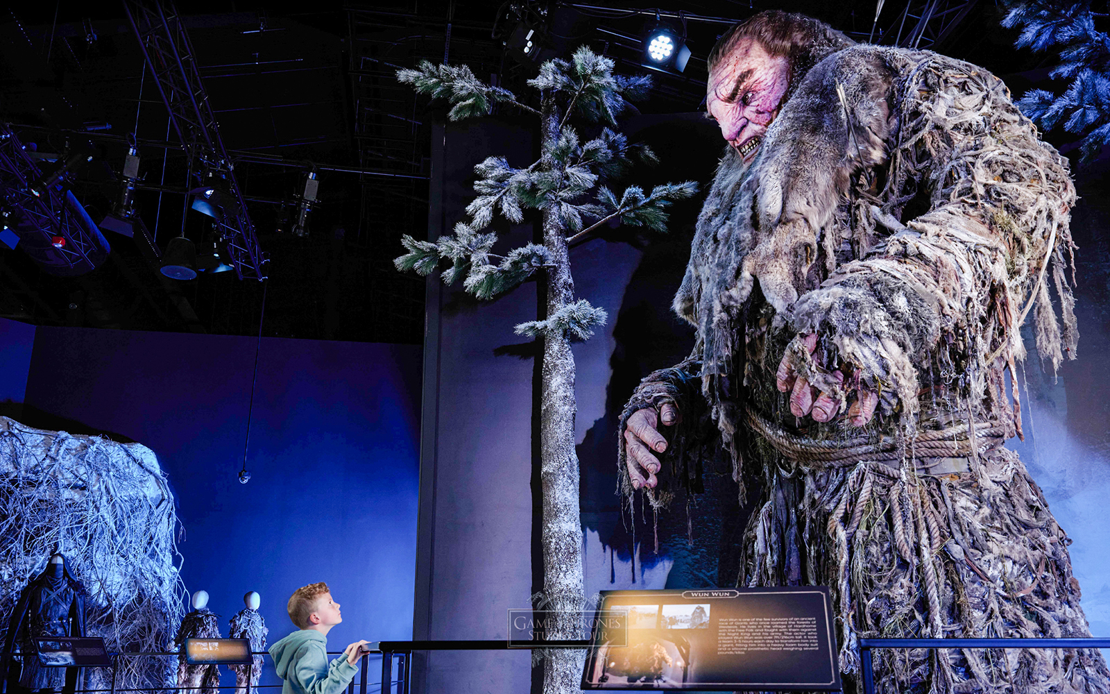 Giant figure display at Game of Thrones Studio Tour with visitor observing.