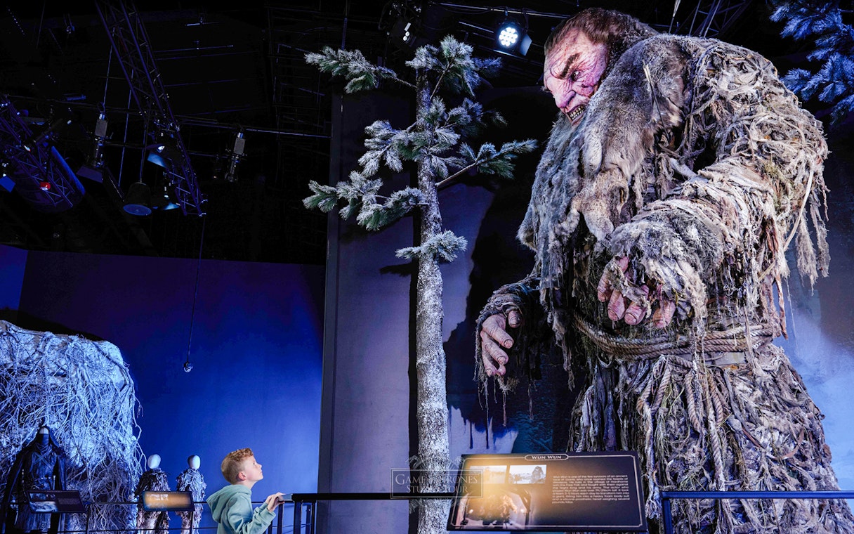 Giant figure display at Game of Thrones Studio Tour with visitor observing.