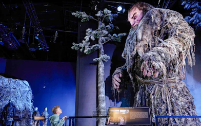 Giant figure display at Game of Thrones Studio Tour with visitor observing.