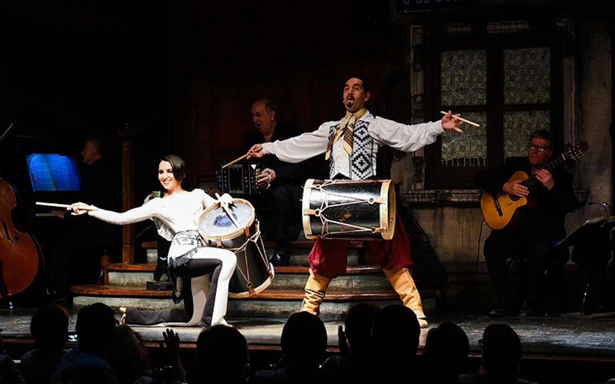 Tango artists performing with drums at Aljibe Tango Show in Buenos Aires.