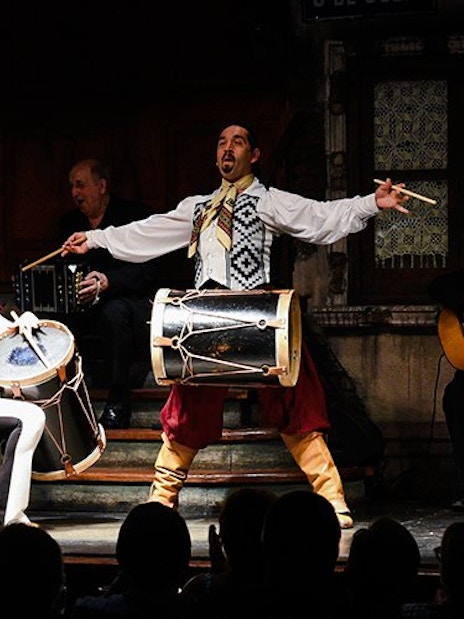 Tango artists performing with drums at Aljibe Tango Show in Buenos Aires.