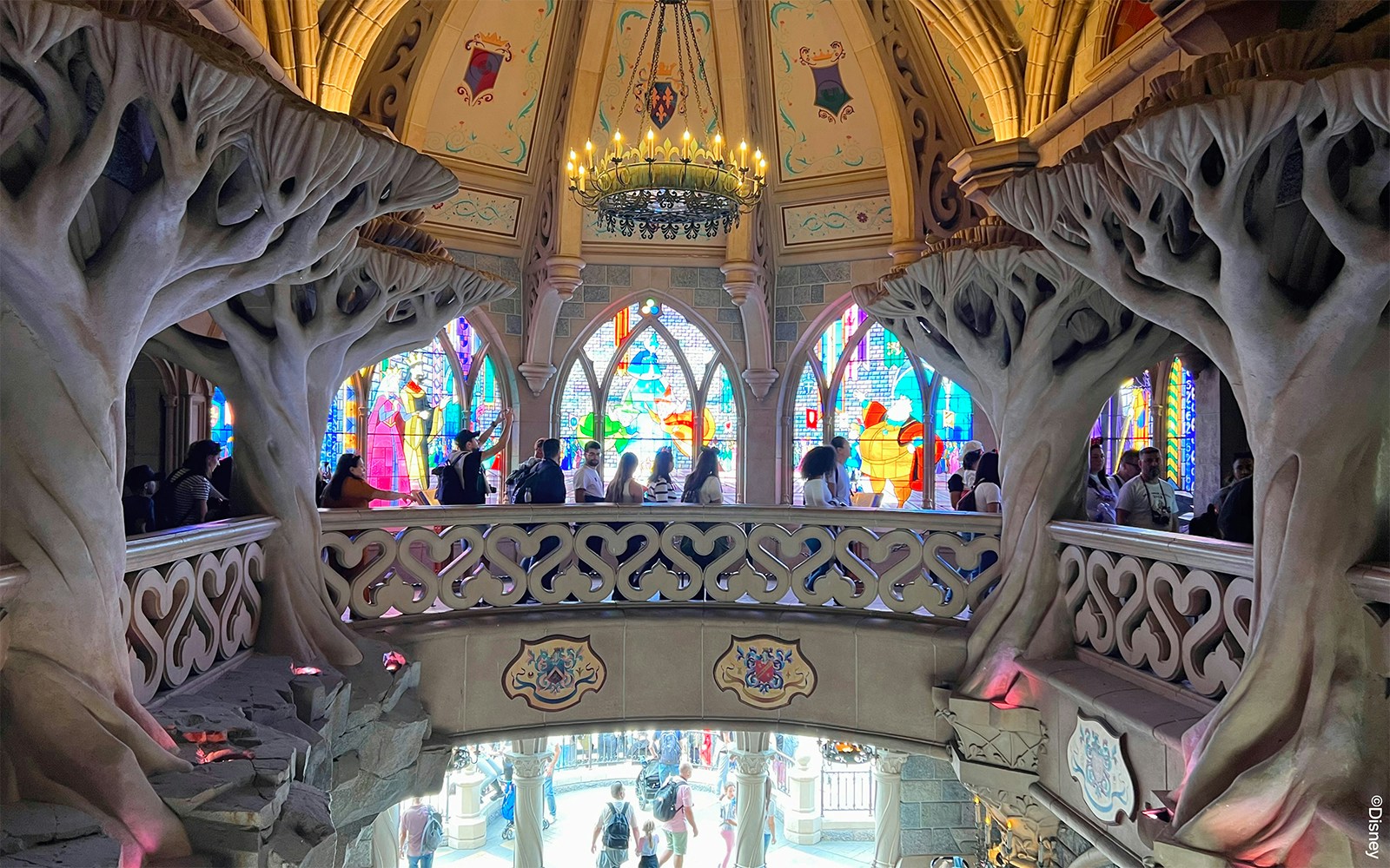 Sleeping Beauty's Castle at Disneyland Paris with vibrant blue turrets and stone archway.