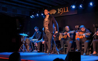 Tablao Flamenco 1911 show with dancer and musicians performing on stage.