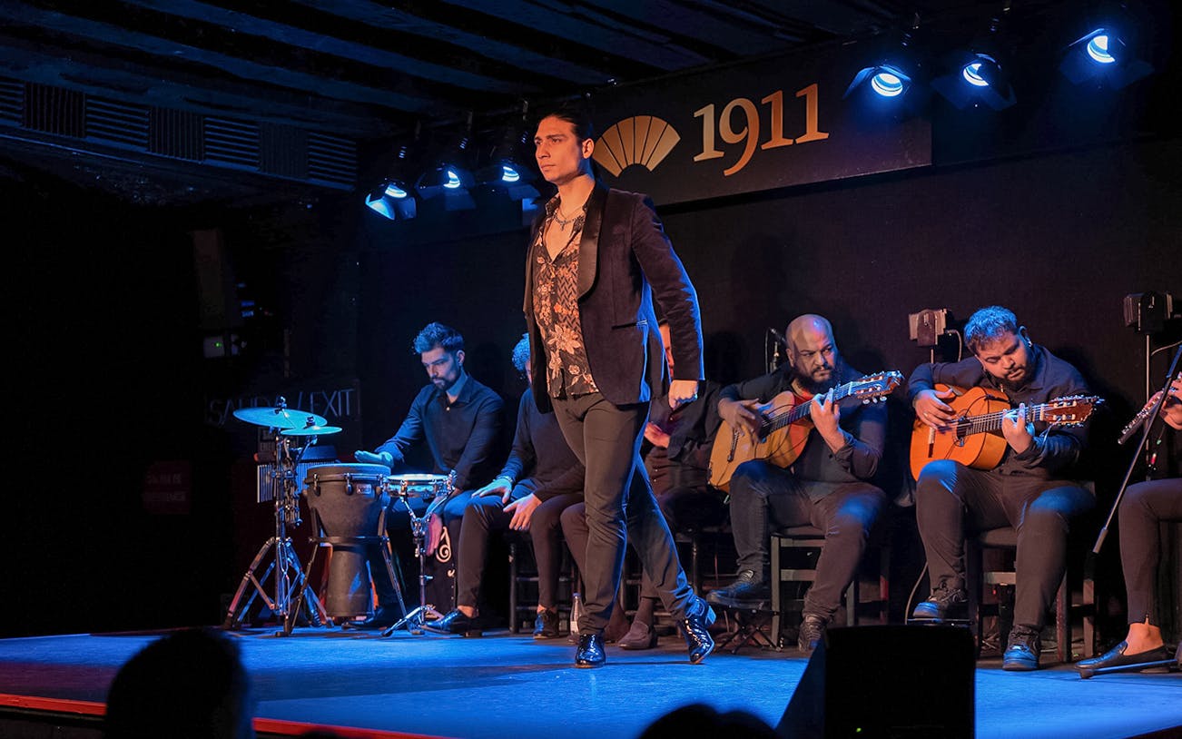 Tablao Flamenco 1911 show with dancer and musicians performing on stage.