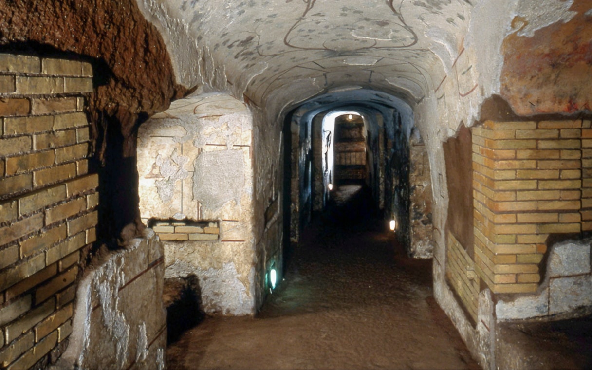 Catacombs of Domitilla corridor with ancient brick walls, Rome.