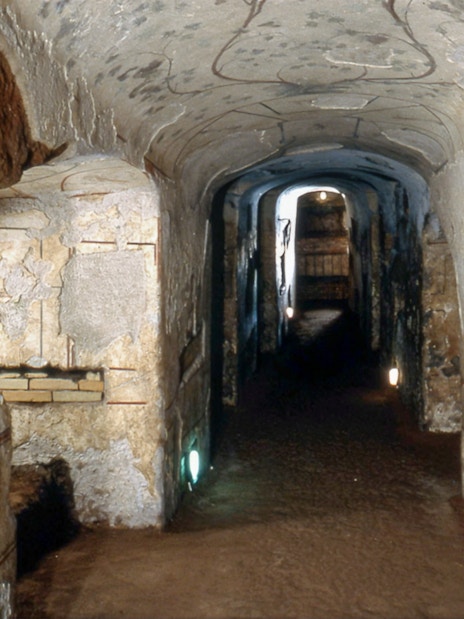 Catacombs of Domitilla corridor with ancient brick walls, Rome.