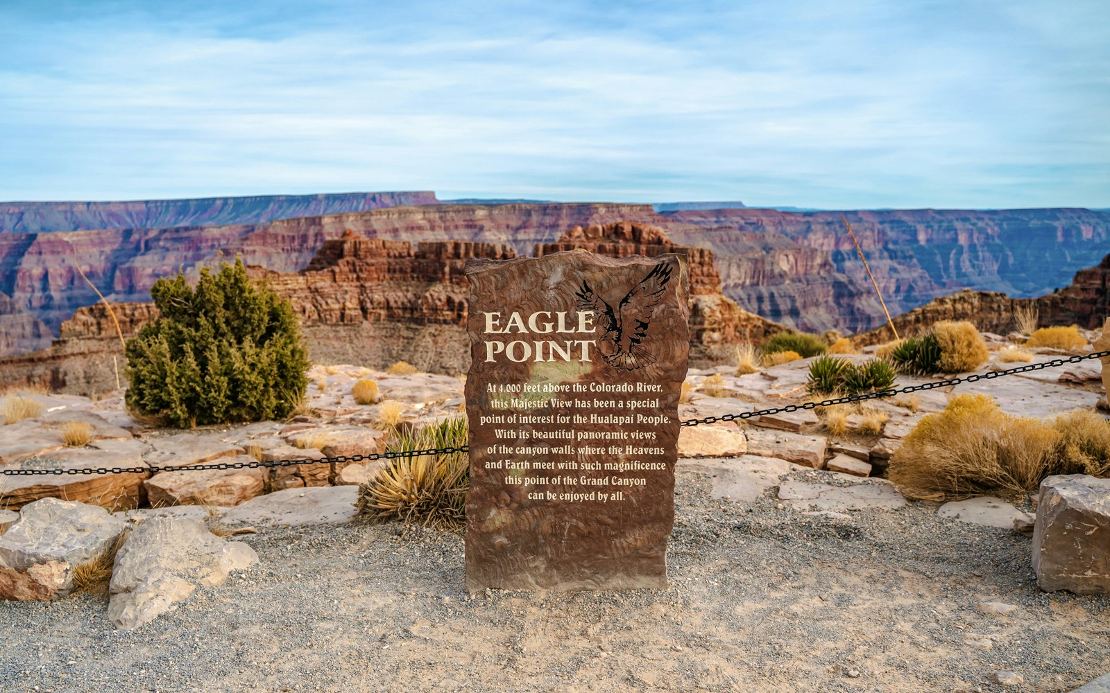 Eagle Point sign at Grand Canyon West, Arizona, with scenic canyon view in the background.