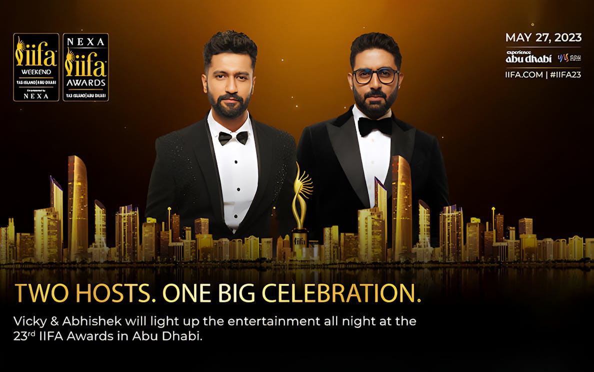 Two hosts at the 23rd IIFA Awards 2023 in Abu Dhabi with city skyline.