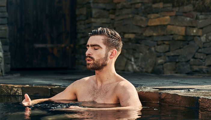 Man relaxing in geothermal poo