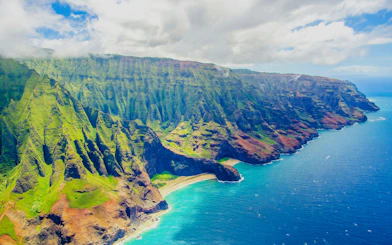 Aerial view of Na Pali Coast cliffs and ocean on a private Kauai air tour.