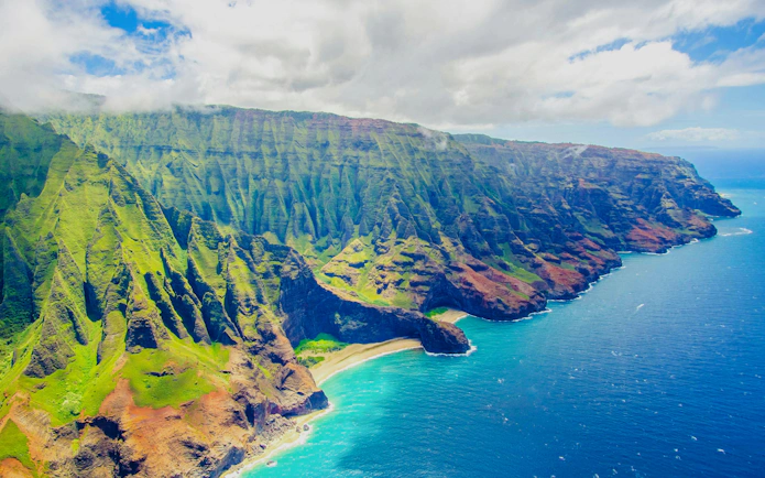 Aerial view of Na Pali Coast cliffs and ocean on a private Kauai air tour.
