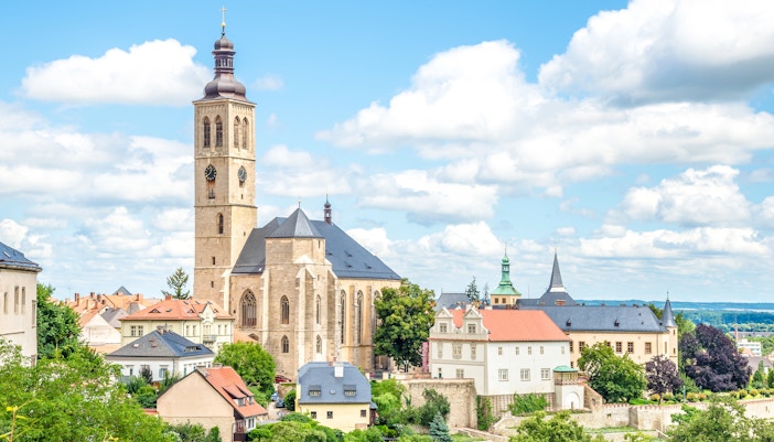 Church of Saint James in Kutna Hora with surrounding historic buildings and greenery.