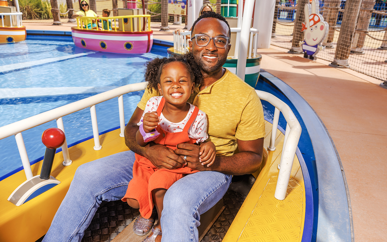 Father and daughter enjoying a boat ride at Peppa Pig Theme Park, Florida.