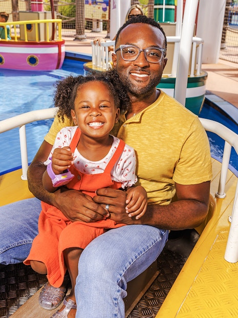 Father and daughter enjoying a boat ride at Peppa Pig Theme Park, Florida.