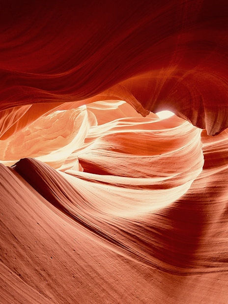 Upper Antelope Canyon's swirling sandstone formations illuminated by sunlight.