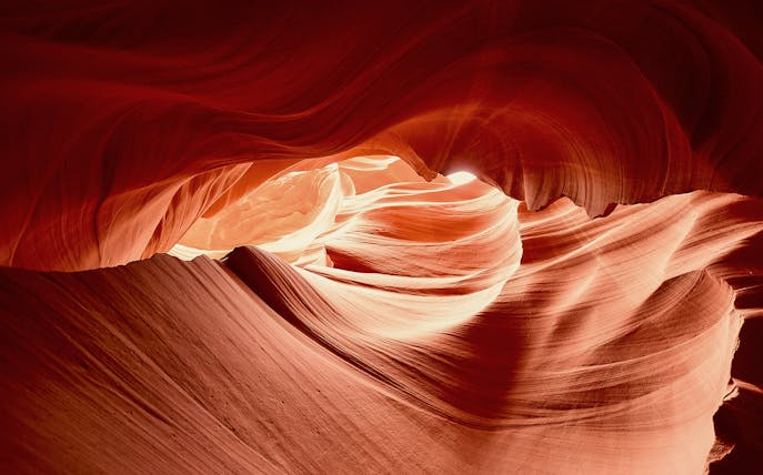 Upper Antelope Canyon's swirling sandstone formations illuminated by sunlight.