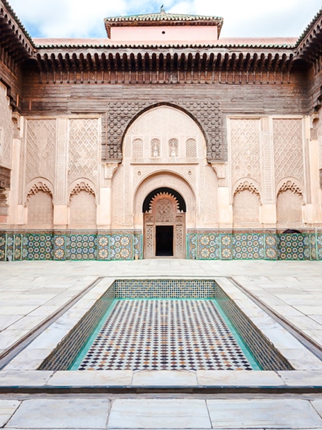 Ben Youssef Madrasa courtyard with intricate tilework in Marrakech, Morocco.