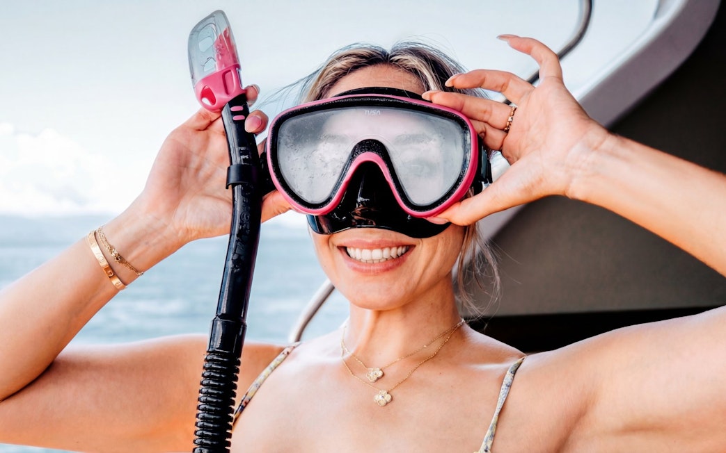 Snorkeler preparing gear on West Nusa Penida Island tour.
