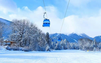 Ski lift over snowy landscape at a Hokkaido resort.