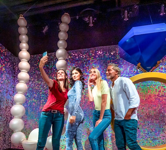 Visitors taking a selfie with a wax figure at Madame Tussauds Dubai.