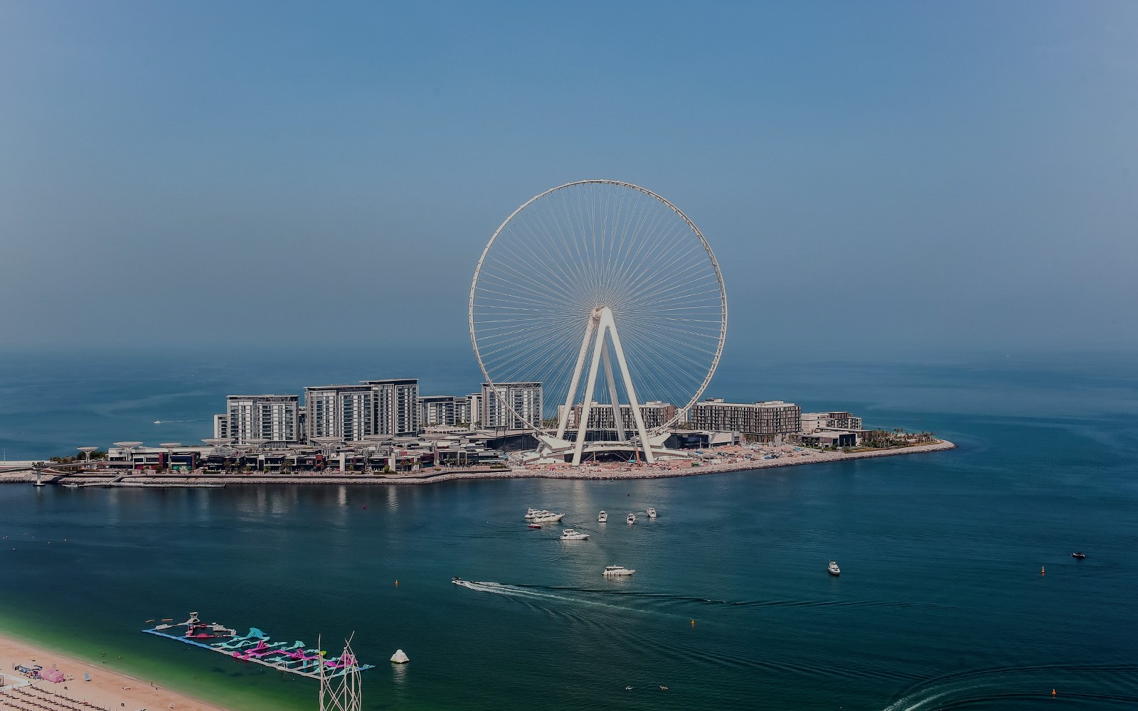 Ferris Wheel on Bluewaters Island, Dubai, with surrounding waterfront and buildings.